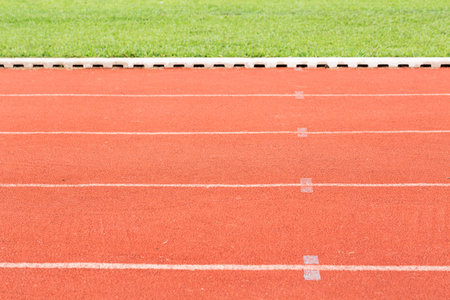 Close up running track outdoor with blurry glasses background.