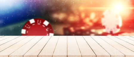 Panorama vintage wooden tabletop with blurry poker chips on the table in casino for montage display...