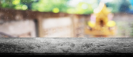 Panorama vintage grunge concrete tabletop with blurry concrete wall with golden building outdoor with snow effect for display your product.の写真素材