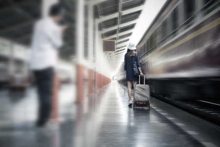 Dangerous Journey of Woman Concept, Voyeur unknow person following for take a photo the tourist woman at train station.の写真素材