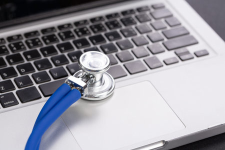 Stethoscope with computer laptop, close up.
