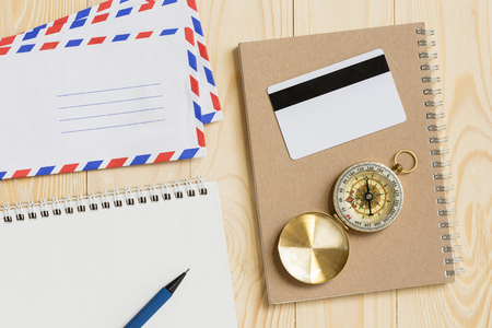 Office desk with notebook, credit card, compass, calendar and develope, view from aboveの写真素材