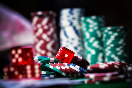 Poker Chips in casino gamble green table.
