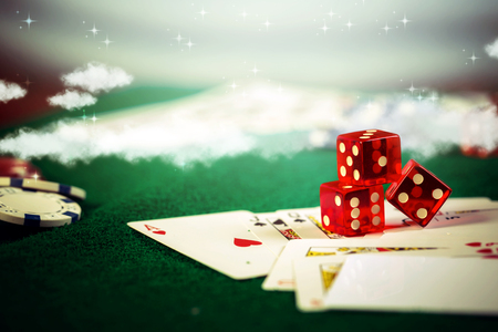 Casino dice with poker chips in gamble green table.の写真素材