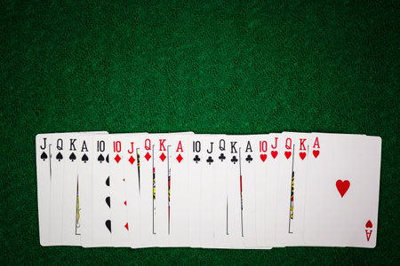 Casino cards on green gamble fabric table.