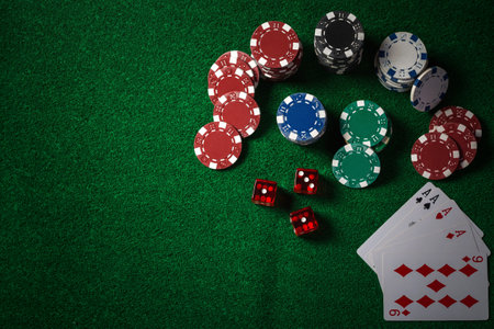 Poker Chips on casino gamble green table, dark tone.