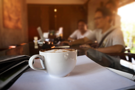 Close up at cup of coffee, business meeting at coffee shop.の写真素材