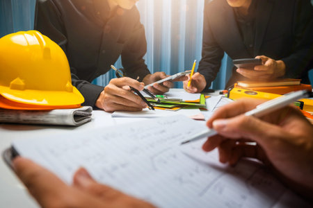 Teamwork of business man contractor working meeting in the office construction site on their...