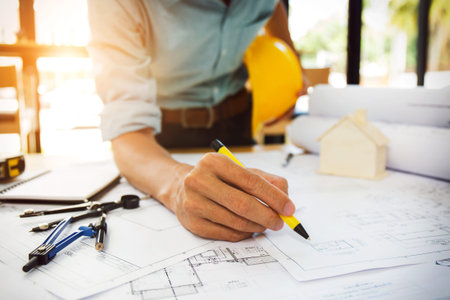 Team of construction engineer working hard project blueprint to build large commercial buildings and...