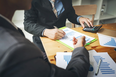 Business man using calculator to calculating.の写真素材