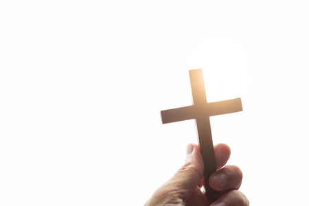 Vintage hand of a Christian man holding a cross with faith in God.の写真素材