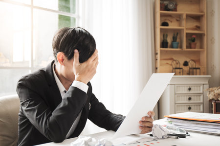 Asian male businessman professional lawyer is tired and migraine headaches during hard work in the...