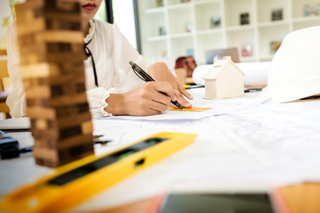 Architect construction engineer plan on hard project at work with vintage tone hipster picture style.の写真素材