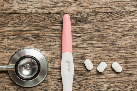 Top view medical pregnancy test on old wooden desk.の写真素材