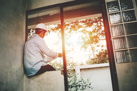 Architect contractor engineering working alone at site construction house building to renovation an old house.の写真素材
