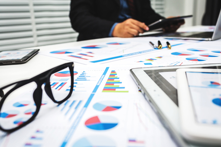 Bankers are analyzing financial data. To sum up the deposit and withdraw daily.の写真素材