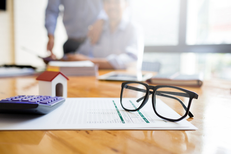Business man working desk with financial paperwork data about loan agreement with financial institution To buy real estate that is sold by public auctionの写真素材