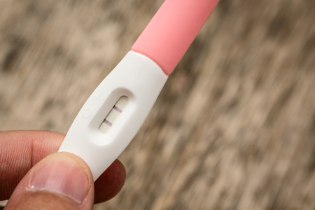 Close up hand holding medical pregnancy test.の写真素材