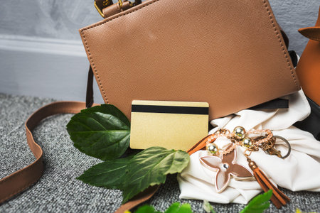 Golden credit card over brown bag woman accessories for go to shopping at shopping mall on weekend.