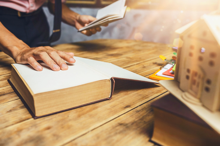 Real estate agent broker working hard to insurance house cash loan for customer service at his office workplace.の写真素材