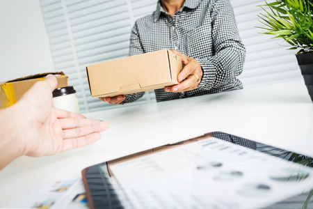 Asian business woman with package box SMEs own private shop.の写真素材