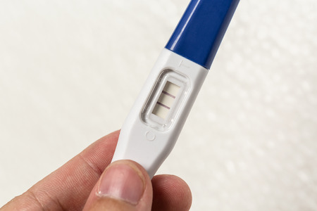 Close up hand holding medical pregnancy test.の写真素材