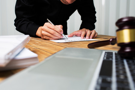 Young lawyer working hard alone in his office.の写真素材