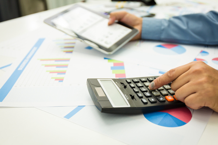 Businessman using a personal income tax calculator. To send information to the Revenue.の写真素材