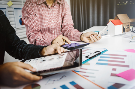 Girl daughter helps mom working in business owner SMEs family business, chart in laptop and document paperwork pile.の写真素材