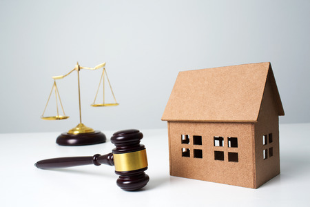 Close up wooden lawyer gavel, scales for new home real estate concept.の写真素材