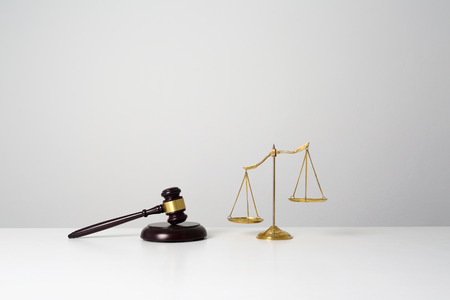 Close up wooden lawyer gavel, scales for new home real estate concept.の写真素材