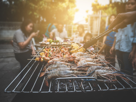 BBQ Party happy summer family dinner at home outdoor vintage style parent and child charcoal stove.の写真素材