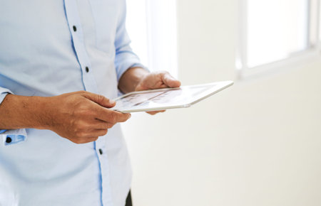 Business man using tablet online calculate profits and loss financial report in the office.