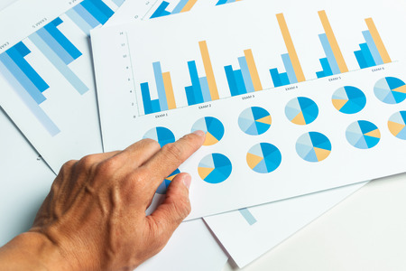 Close up hand of business man with financial report accounting analysis.の写真素材