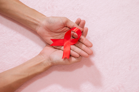 Cancer awareness hand ribbon top view, vintage picture style donate healthcare concept.の写真素材