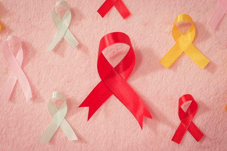 Close up ribbon symbol of cancer awareness multi color top view with pink background.の写真素材