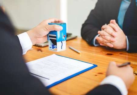 House real estate sell agent reviews the documents that have been approved for the home buyer loan.