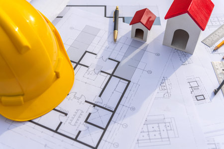 Architect desk with blueprint and hard hat constuction building outdoor objects.
