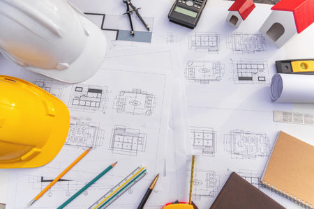 Architect desk with blueprint and hard hat constuction building outdoor objects.