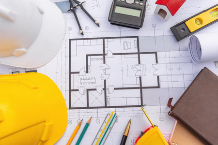 Architect desk with blueprint and hard hat constuction building outdoor objects.