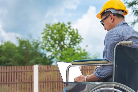 Middle-age Asian person work at home architect house building outdoor morning.の写真素材
