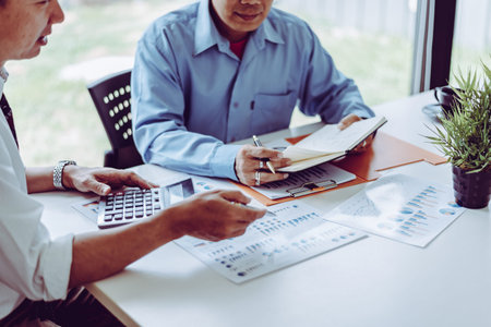 Business meeting asian people two male middle-age discussing while sitting together in modern...