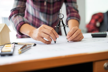 Female architect drawing blueprints in office workplace, one people alone.