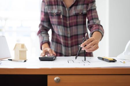 Female architect drawing blueprints in office workplace, one people alone.の写真素材