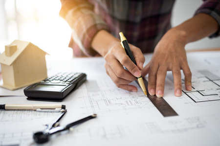 Female architect drawing blueprints in office workplace, one people alone.