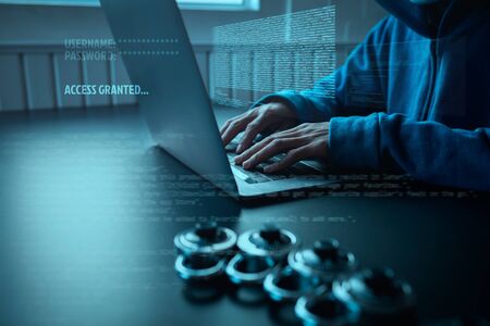 Asian people hacker wear a mask using a laptop cyber attack. Unlocked security via technology computer virus.の写真素材