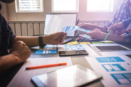 User Experience Teamwork Mobile UX/UI Designers working at co-working space workroom.の写真素材