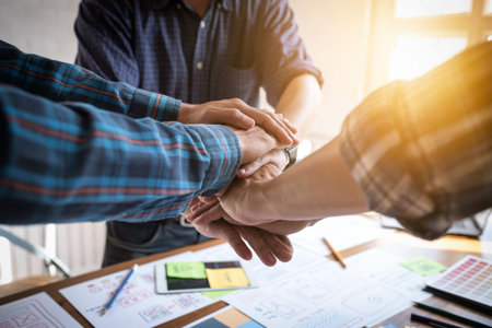 UX/UI Designers joining hands to motivate collaboration after successfully completed the target set.