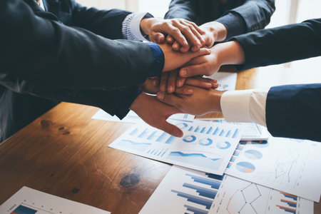 Business partnership large group join hands successful teamwork.