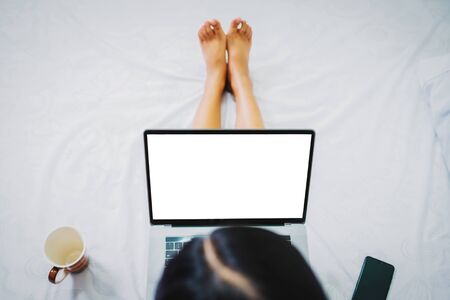 Top view woman with blank screen of laptop while shopping at home or work from home WFH concept.の写真素材